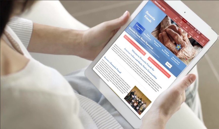 Person holding tablet with information about Dementia Friends program for American Indian and Alaska Native communities
